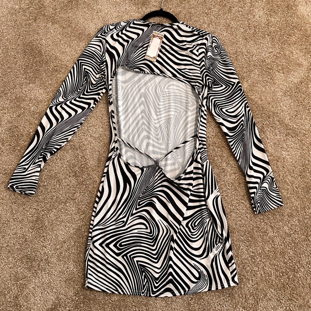 This is a black and white, asymmetrical short dress